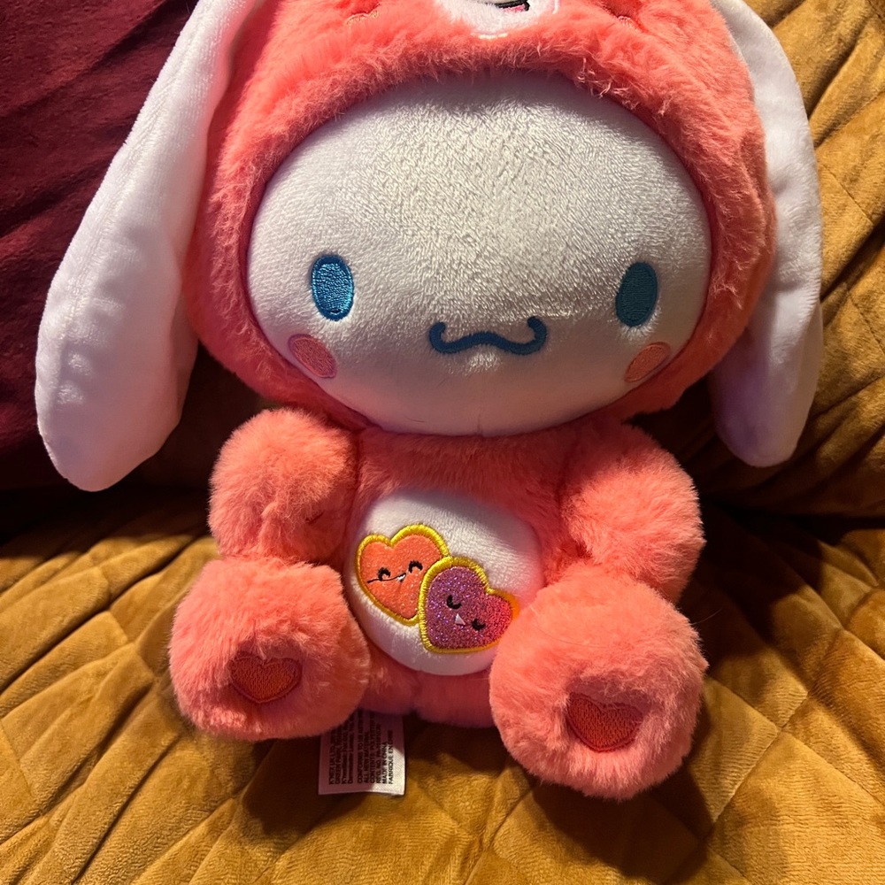 Cinnamoroll dressed as Care Bears Love A Lot Bear